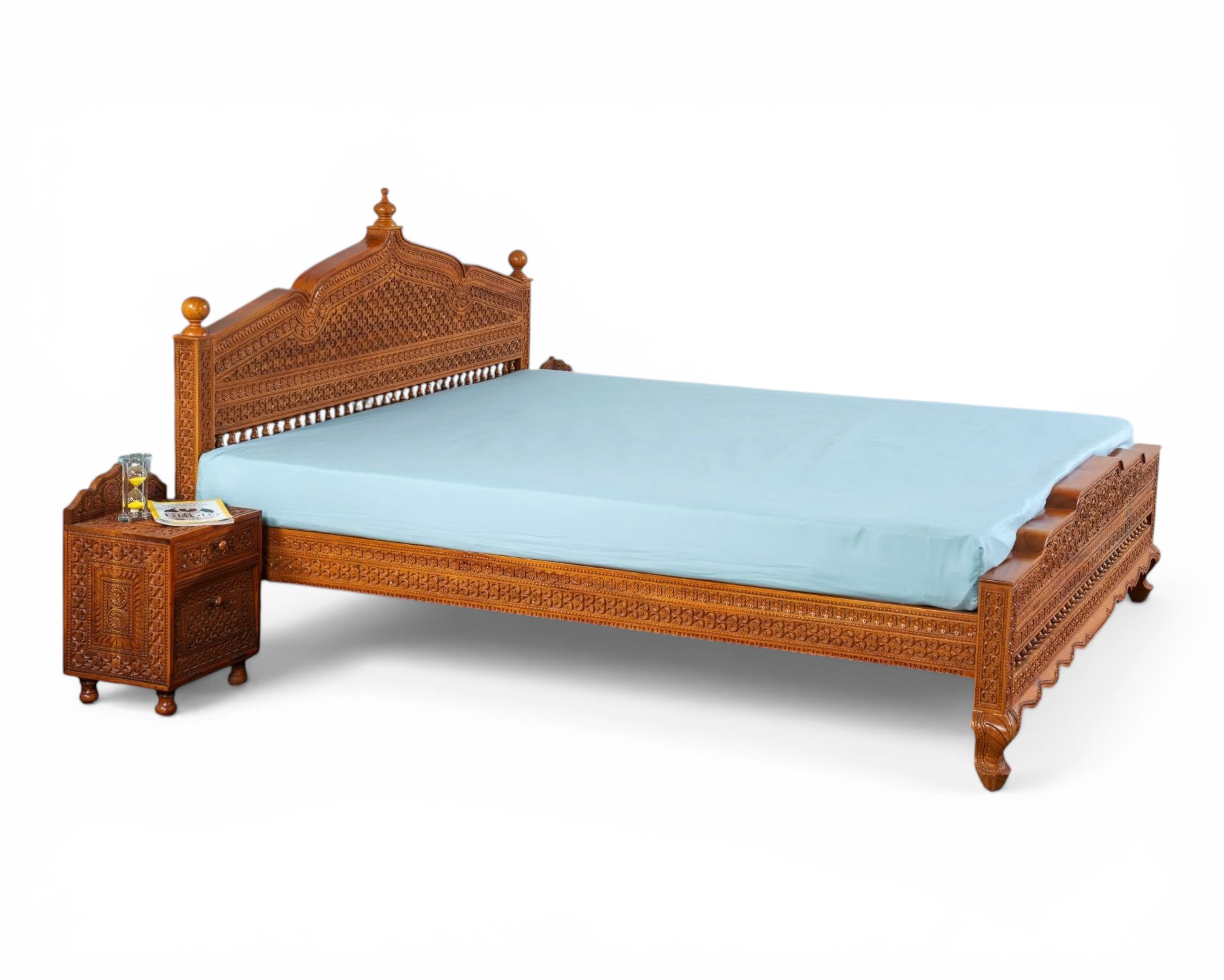Nakoda Homes ornate carved wooden bed frame with intricate details and warm wood finish. Traditional craftsmanship.