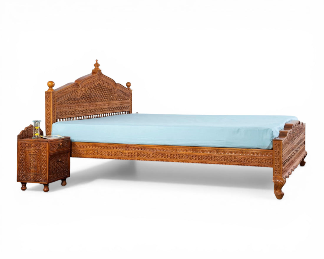 Nakoda Homes ornate carved wooden bed frame with intricate details and warm wood finish. Traditional craftsmanship.