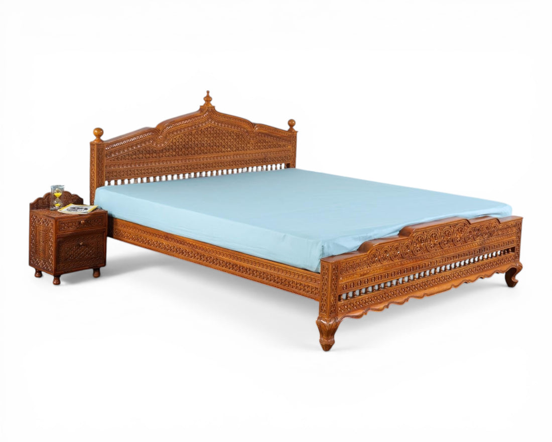 Nakoda Homes ornate carved wooden bed frame with intricate details and warm wood finish. Traditional craftsmanship.