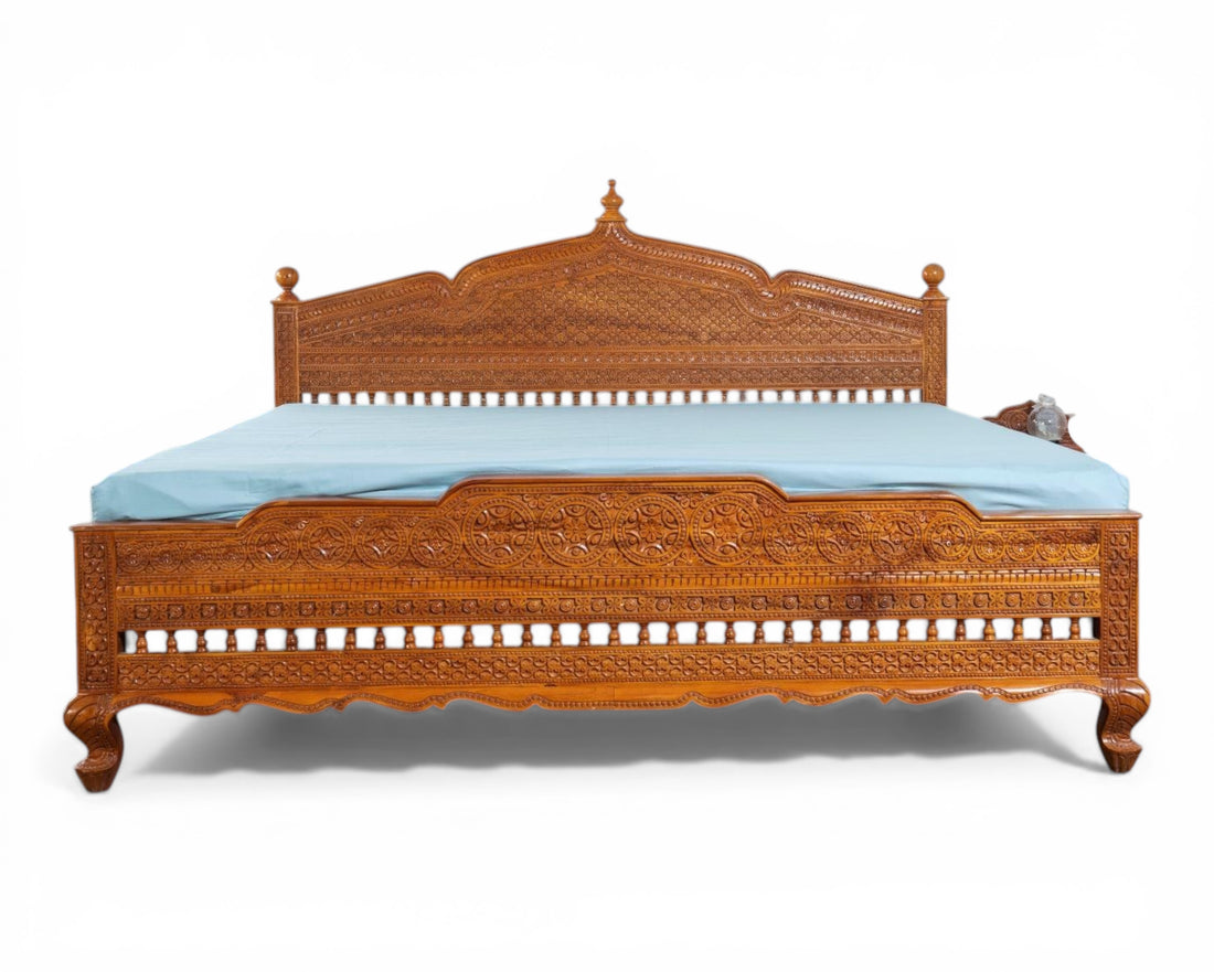 Nakoda Homes ornate carved wooden bed frame with intricate details and warm wood finish. Traditional craftsmanship.