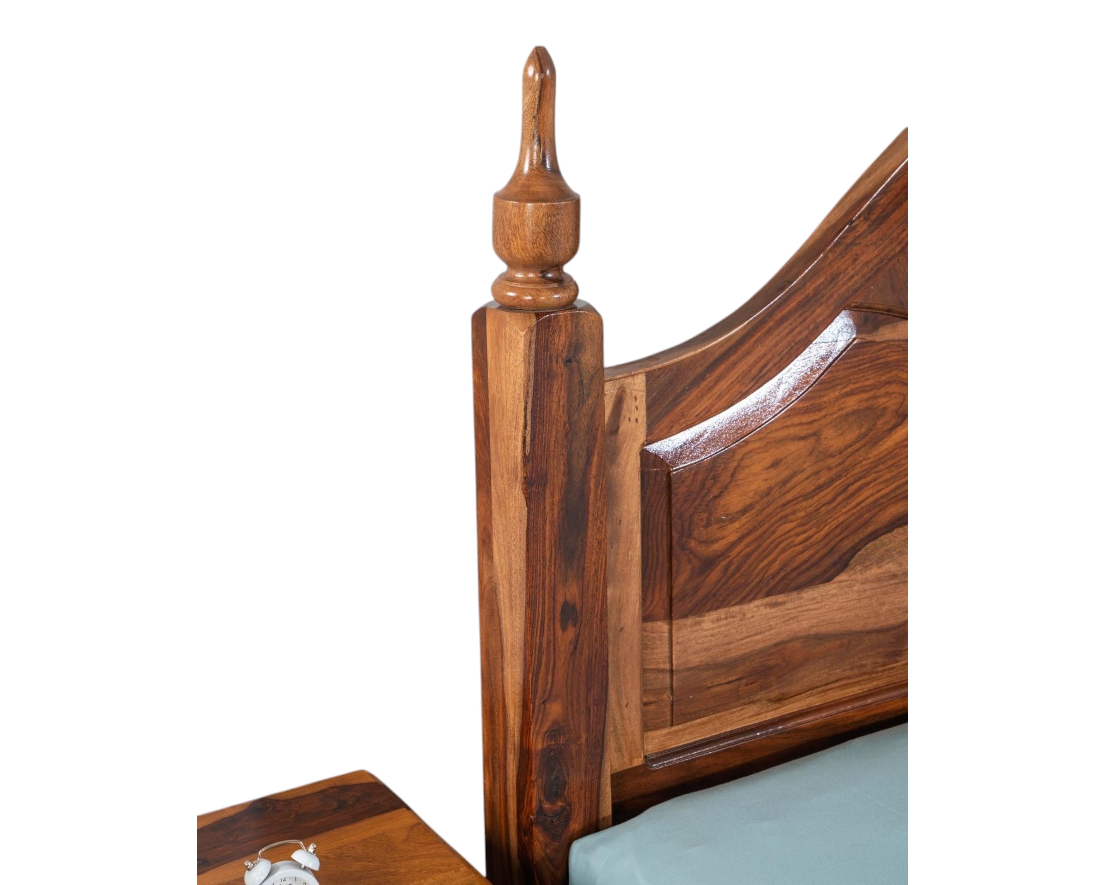 Nakoda Homes Ornate Sheesham wood bed frame with arched headboard and carved posts. Warm wood tones.
