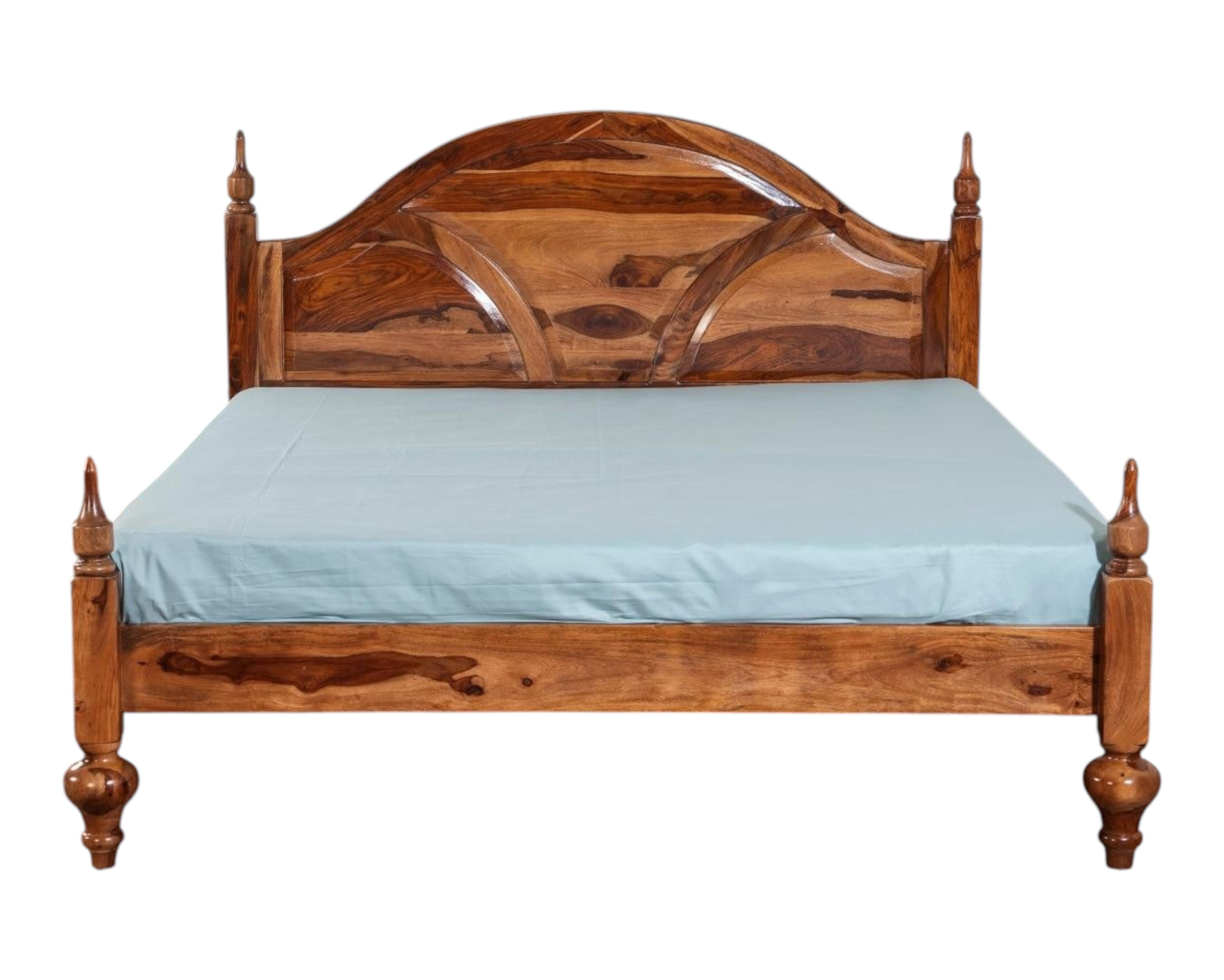 Nakoda Homes ornate Sheesham wood bed frame with arched headboard, intricate carvings, and turned posts. Classic design.