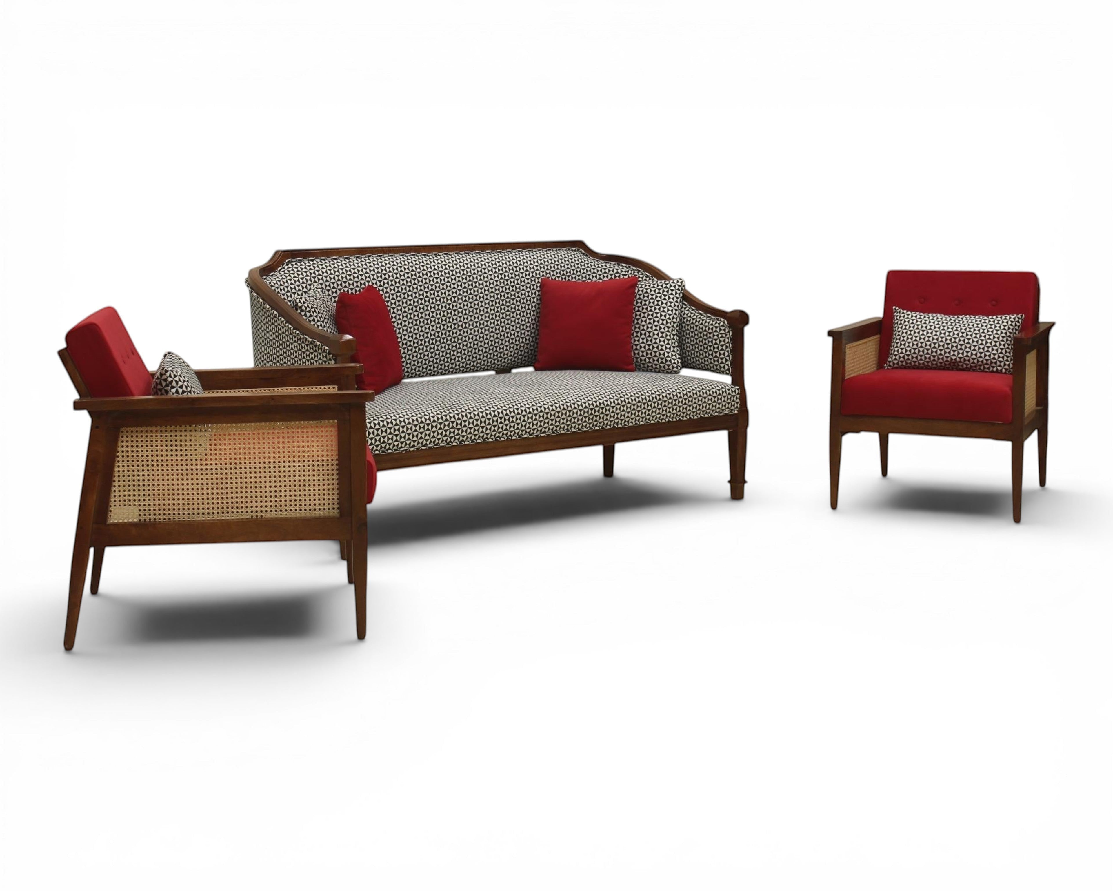 Nakoda Homes classic armchair and sofa set with red upholstery, wooden frame, and cane detailing. Includes accent pillows.
