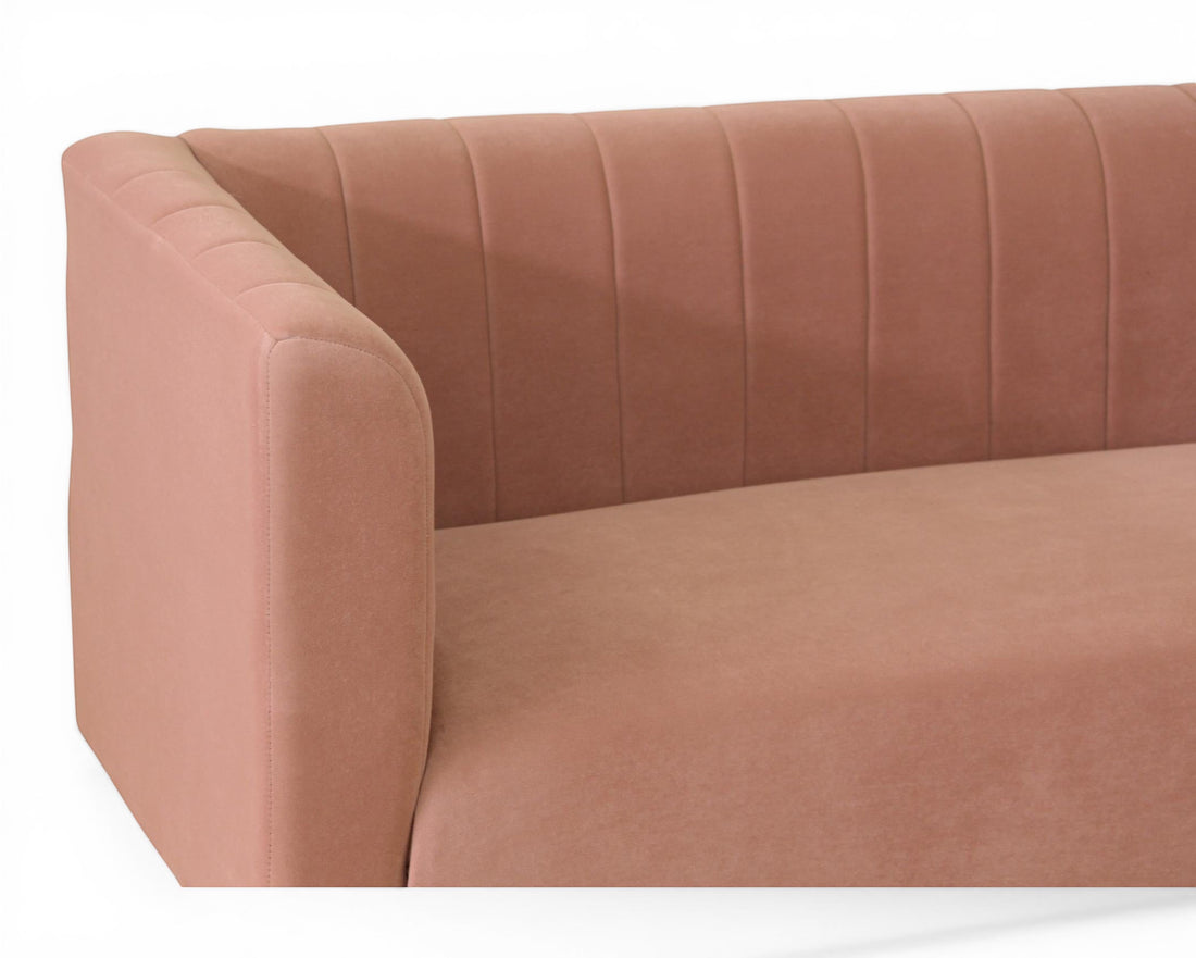Nakoda Homes rose velvet sofa with channel tufting on arms and back. Modern design for living rooms.