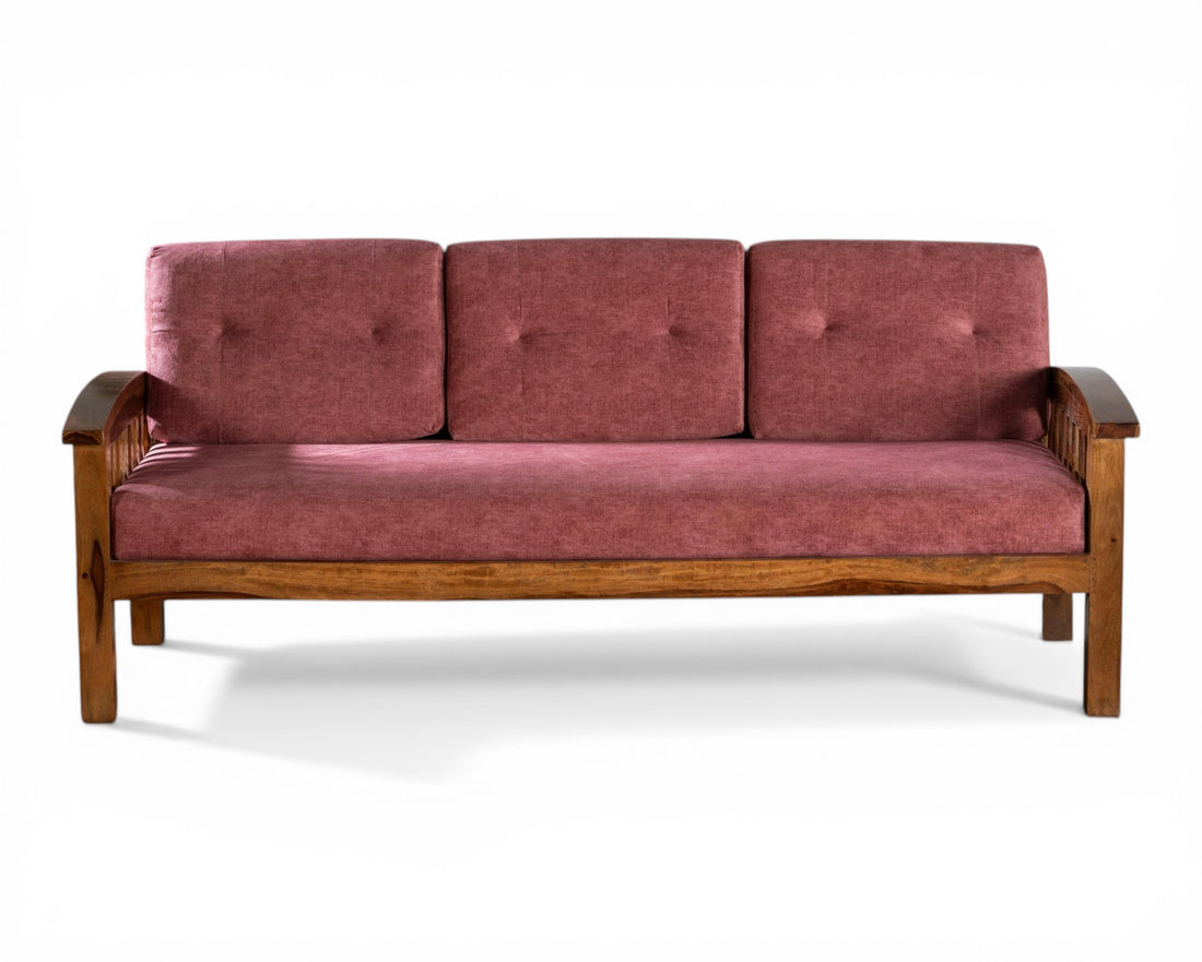 Nakoda Homes modern wooden sofa with rose-colored upholstery and slatted back design. Comfortable and stylish.