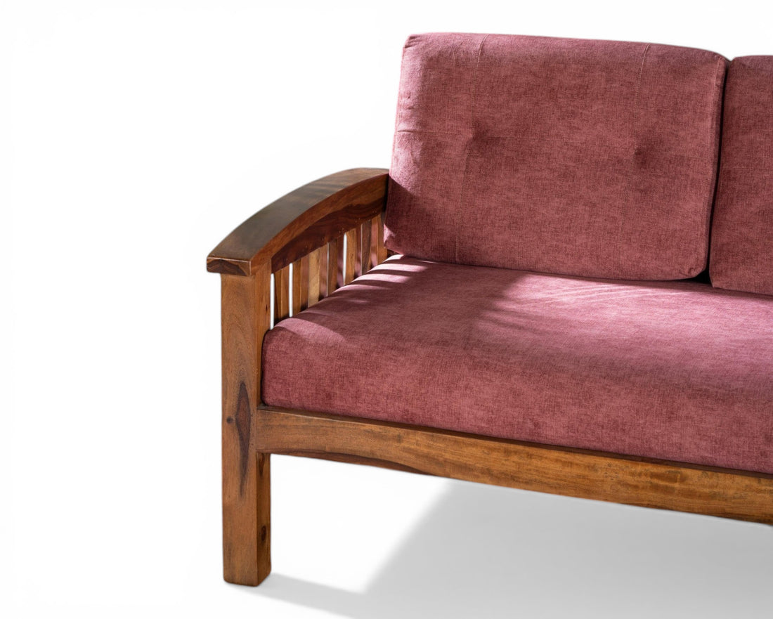 Nakoda Homes modern rose upholstered wooden sofa with slatted back and plush cushions.