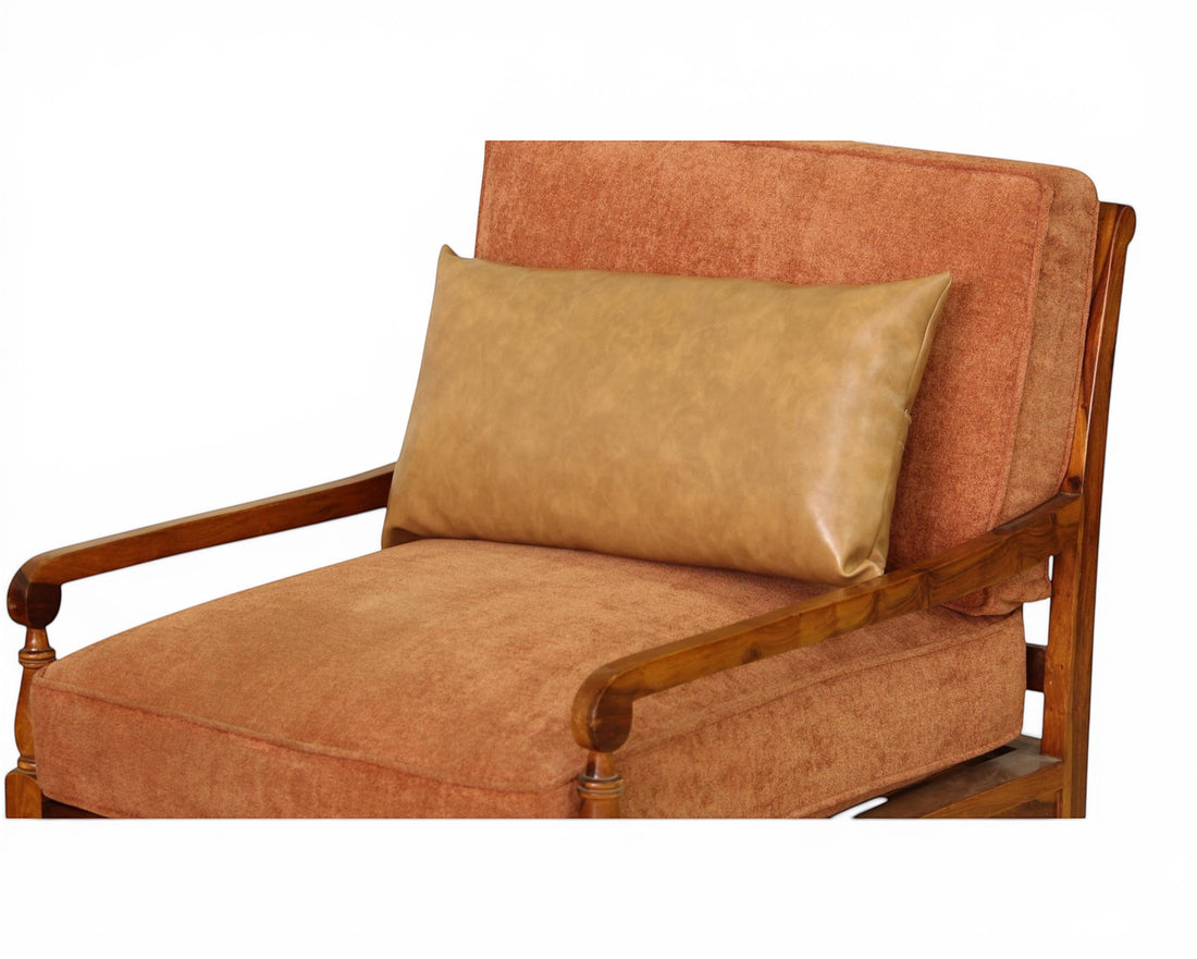Nakoda Homes rust-colored upholstered armchair with wooden arms and tan faux-leather lumbar pillow.