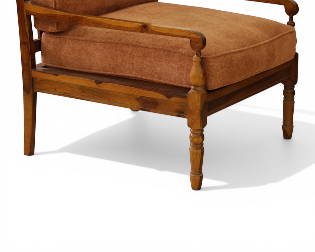 Nakoda Homes rust-colored upholstered armchair with wooden frame and armrests, part of a 3-piece living room set.