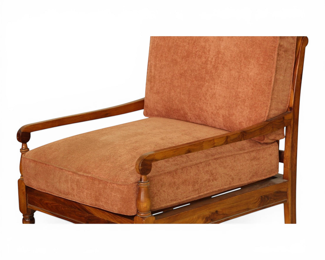Nakoda Homes rust-colored upholstered armchair with wooden frame and armrests, part of a living room sofa set.