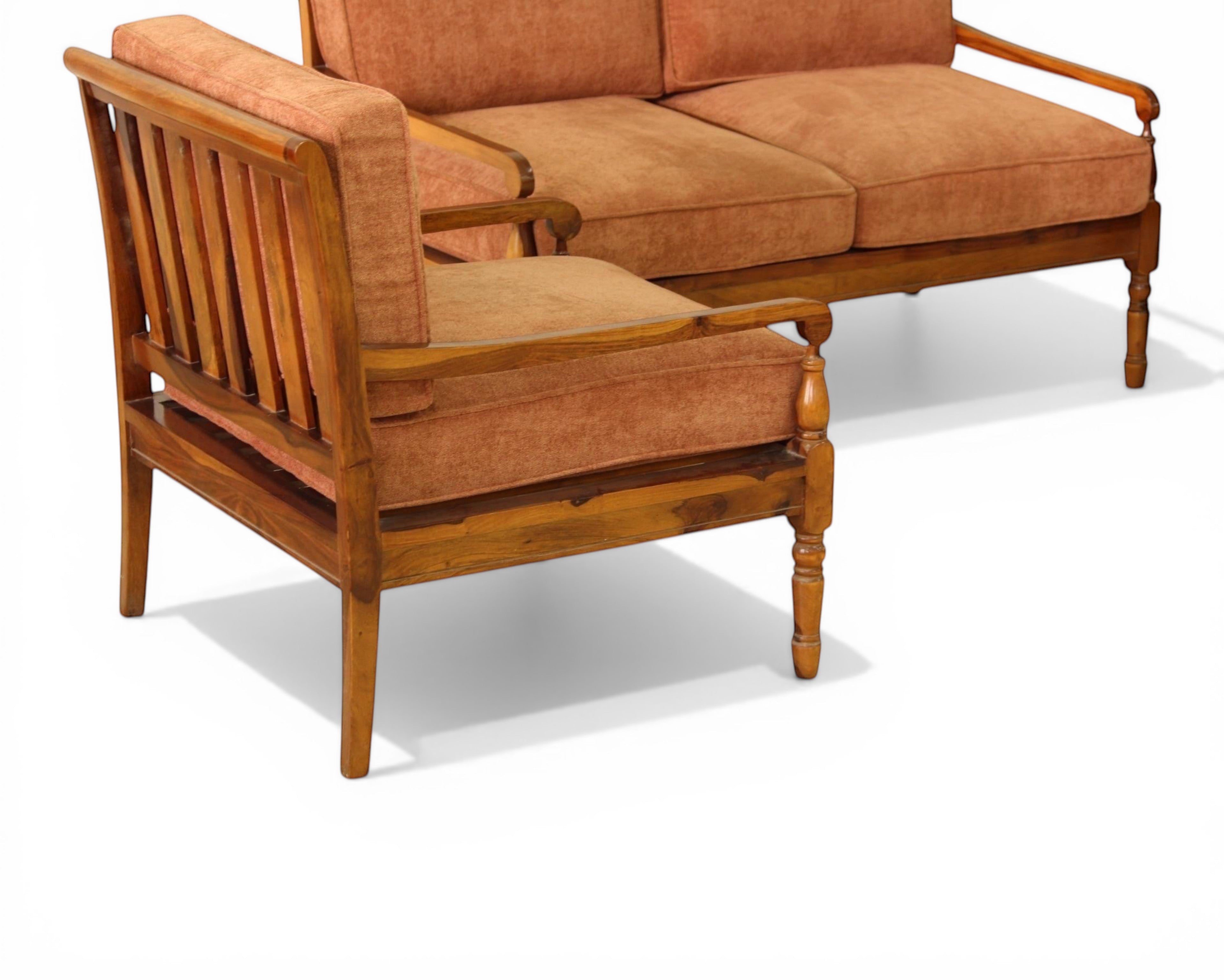 Nakoda Homes rust-colored upholstered 3-piece sofa set with wooden frame and armrests, includes loveseat and two armchairs.