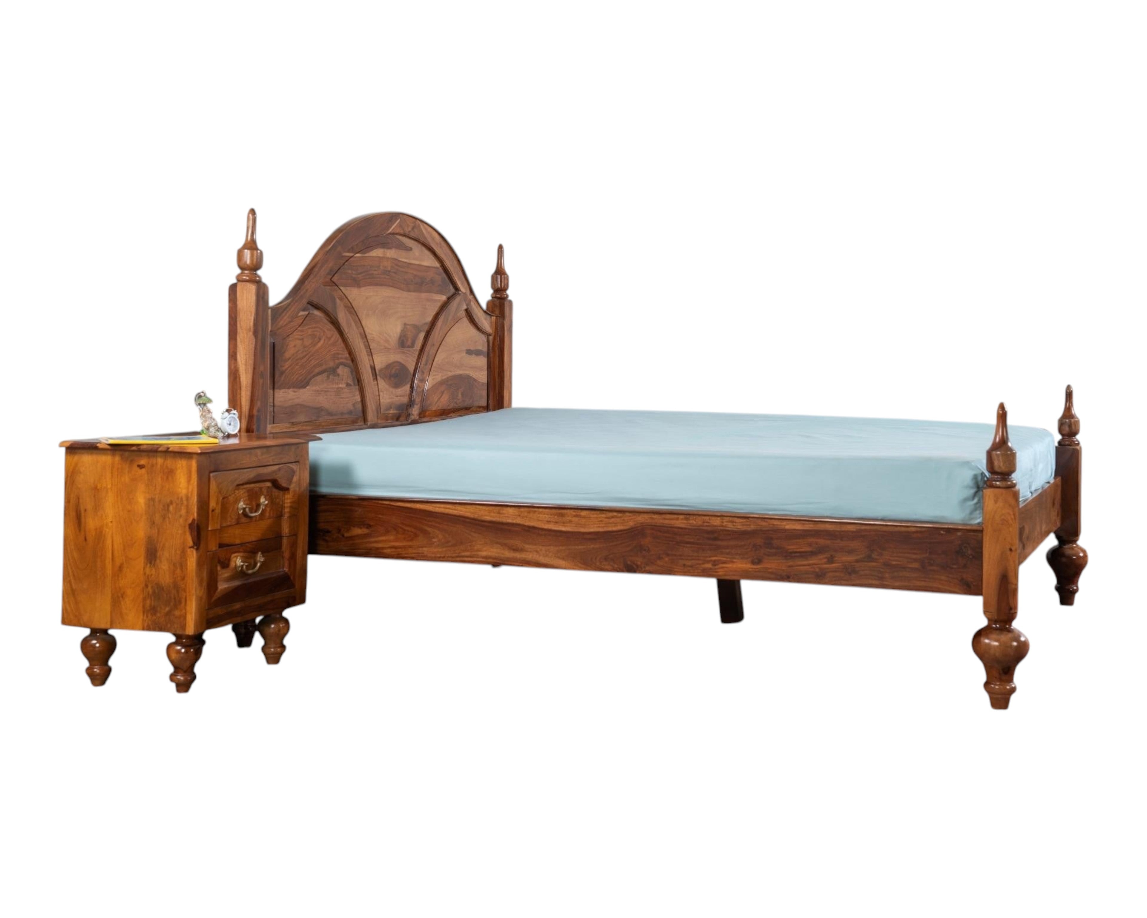 Nakoda Homes solid Sheesham wood bed frame with arched, carved headboard and turned posts. Warm wood tone.