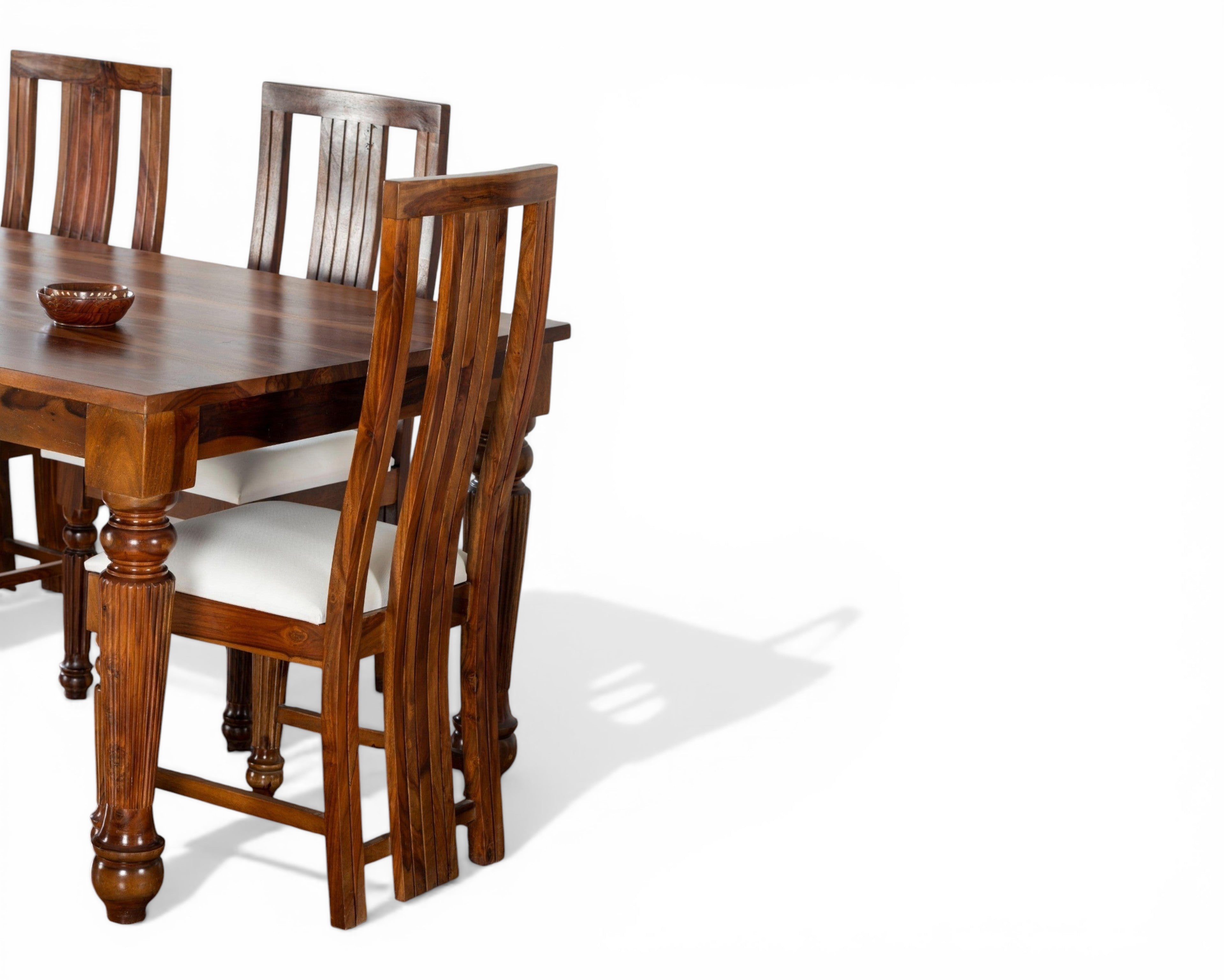 Nakoda Homes Sheesham wood dining set with upholstered white seats and carved legs. Elegant, timeless design.