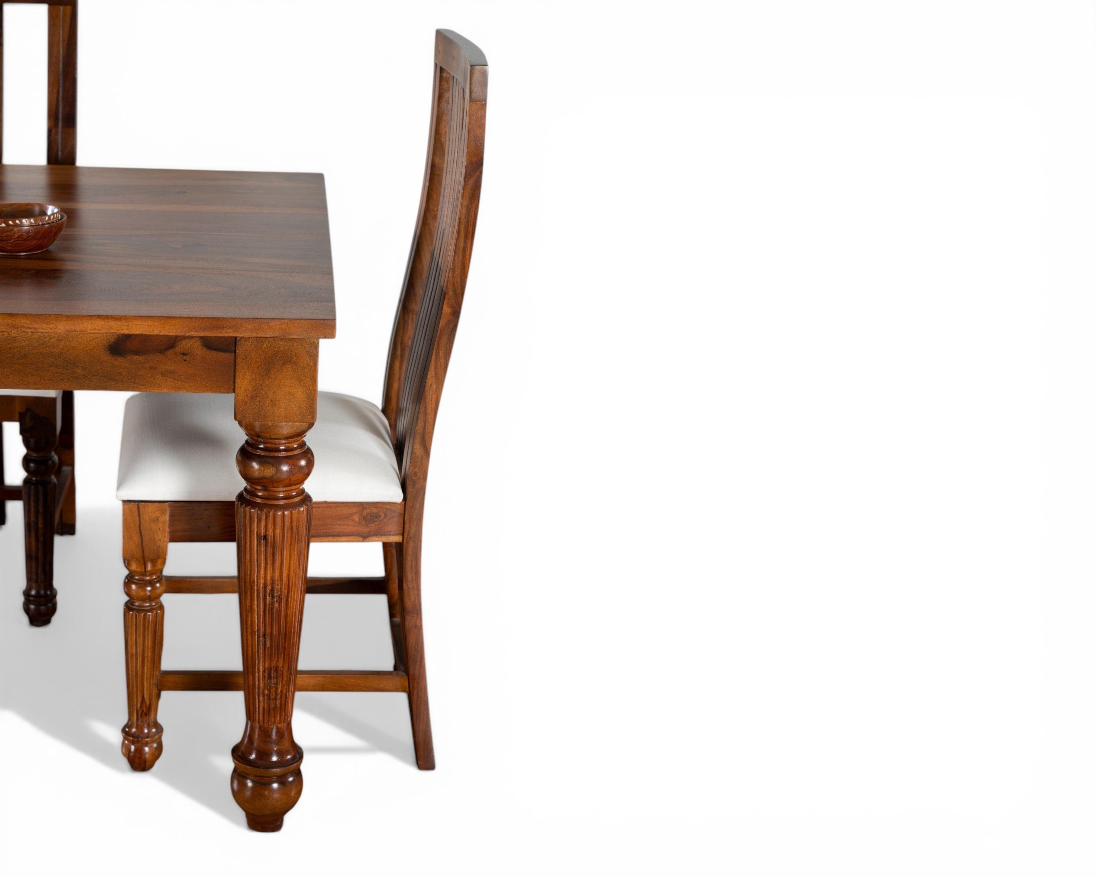 Nakoda Homes Sheesham wood dining set with carved legs and white upholstered seats.