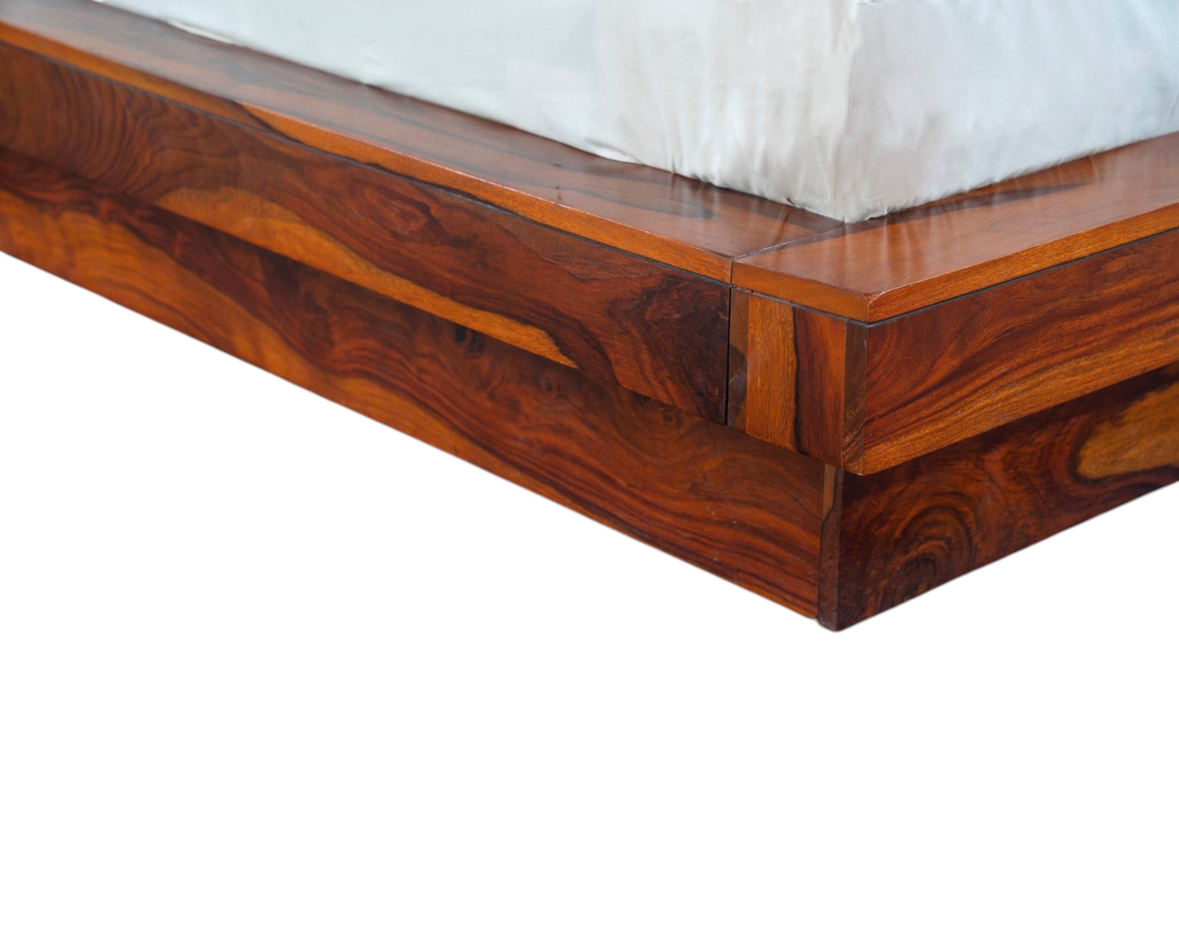 Nakoda Homes solid Sheesham wood platform bed frame with natural grain and low-profile design.