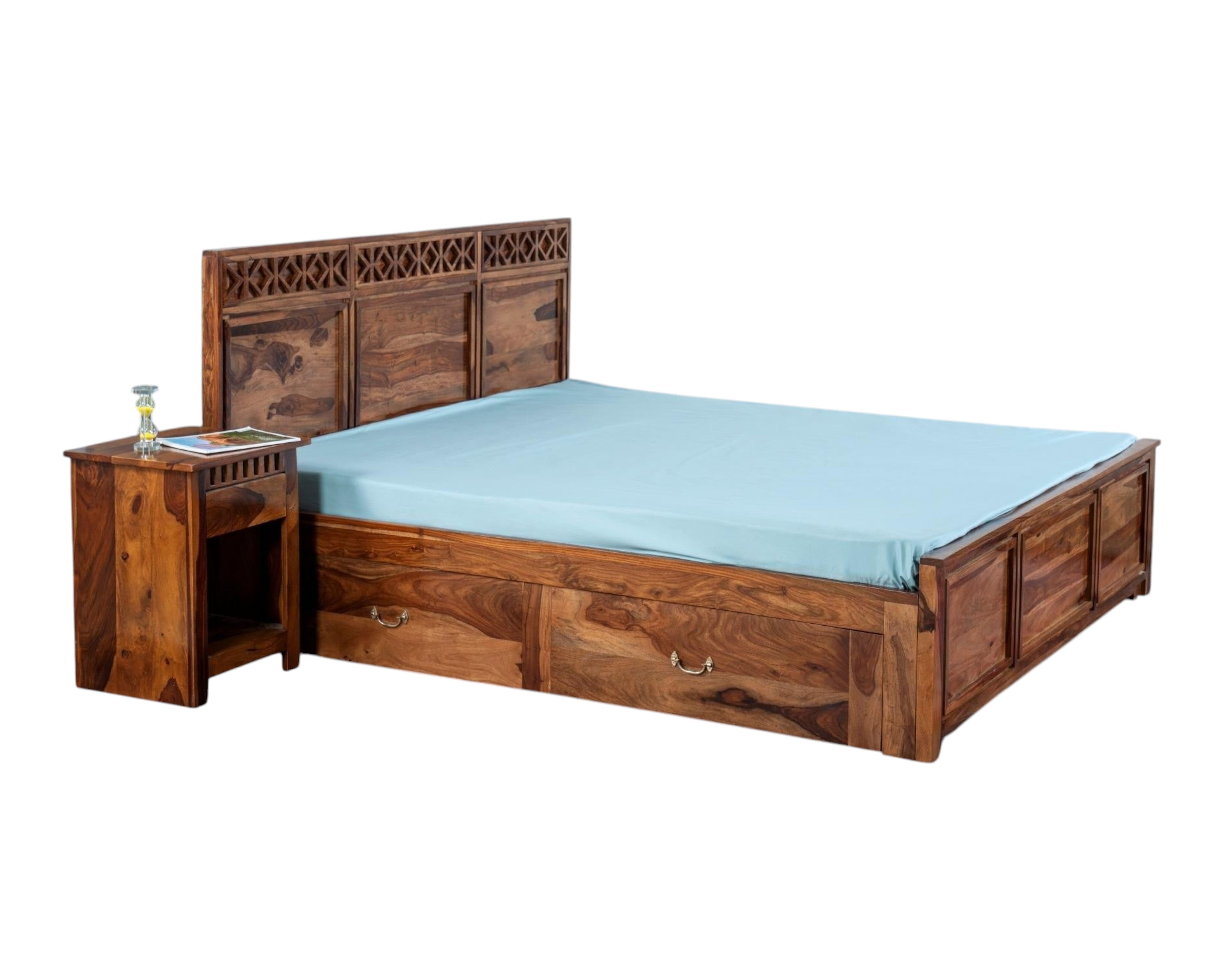 Nakoda Homes Sheesham wood bed frame with carved headboard and storage drawers. Rich wood grain.