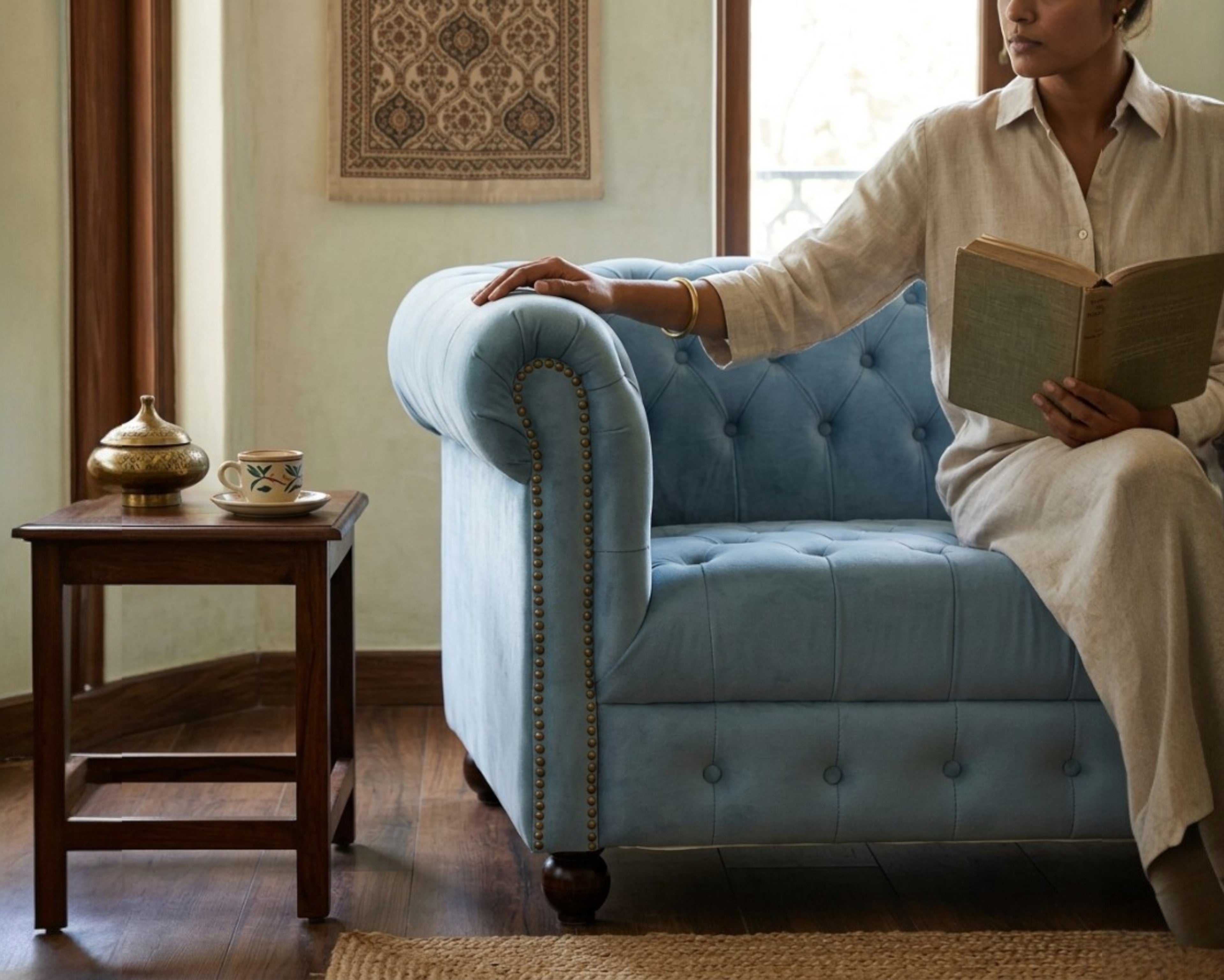 Nakoda Homes sky blue velvet Chesterfield sofa with button-tufting and nailhead trim.