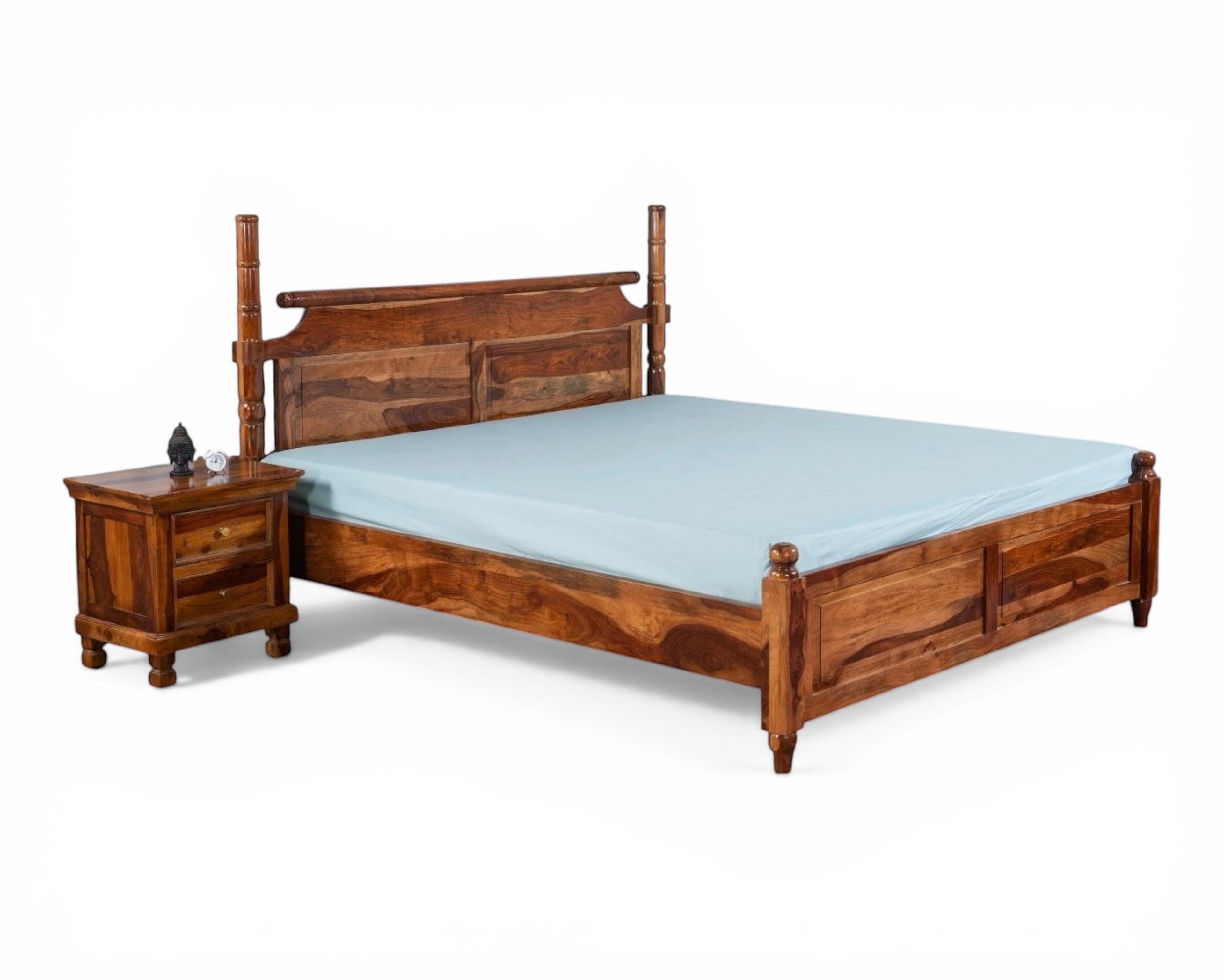 Nakoda Homes queen-size four poster bed frame in solid Sheesham wood with honey-brown finish and carved detailing.