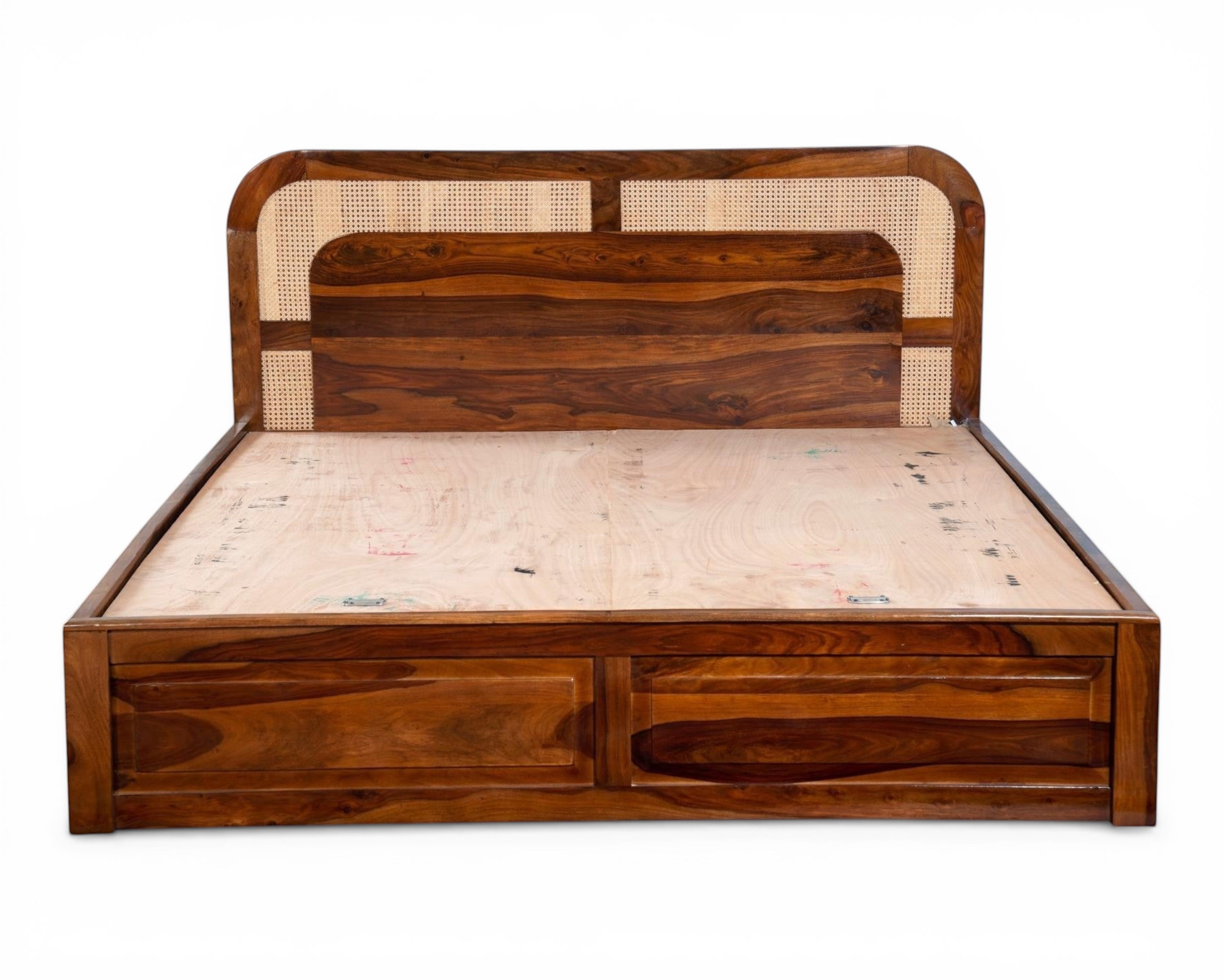 Nakoda Homes solid wood platform bed with cane headboard and storage drawers. Warm wood finish with natural cane detailing.