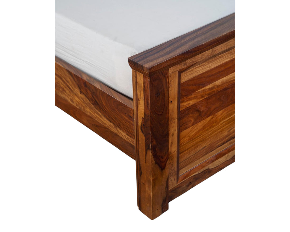 Nakoda Homes solid Sheesham wood platform bed frame with slatted headboard and honey-toned finish.