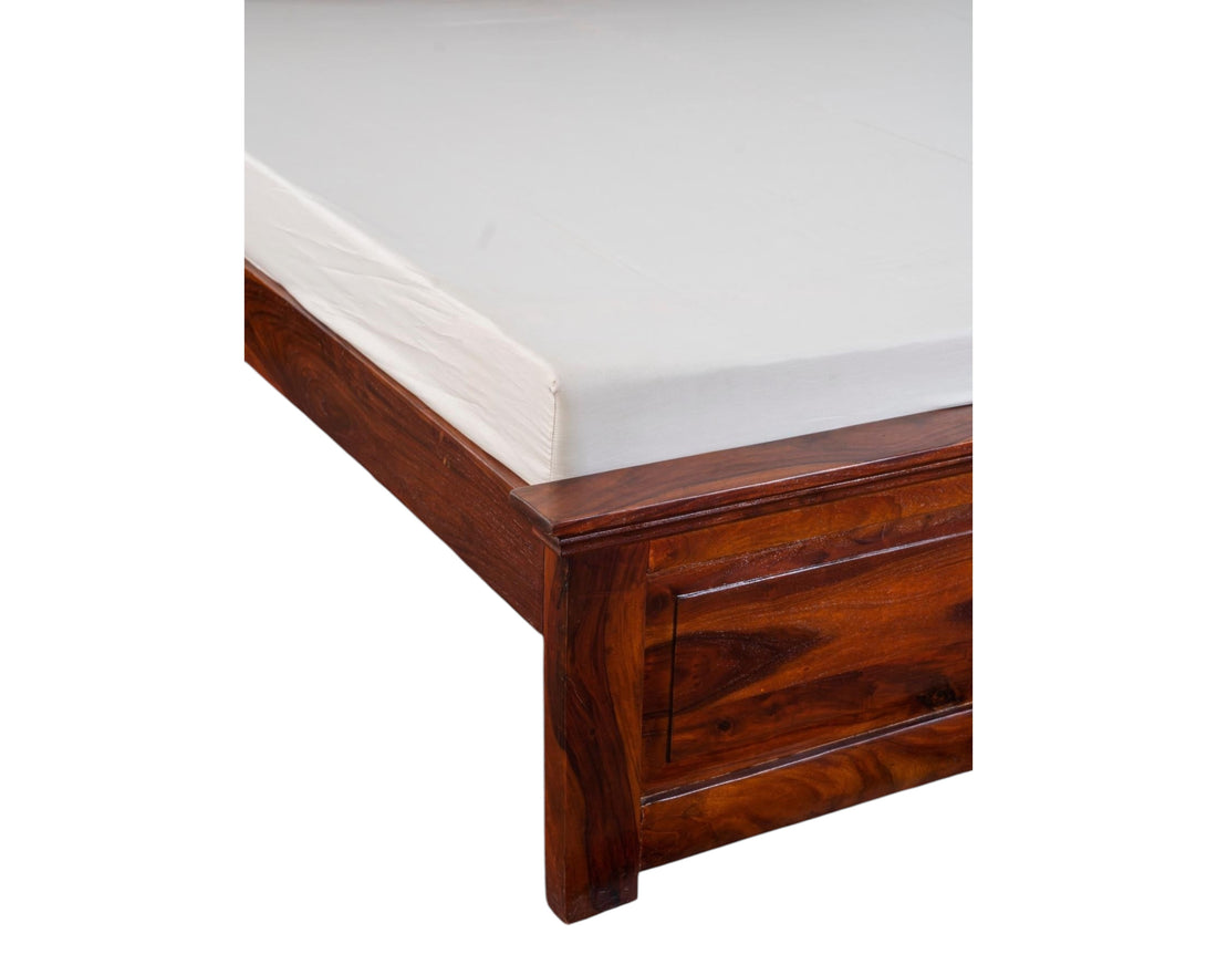 Nakoda Homes solid wood platform bed frame in warm brown with natural grain and elegant detailing.