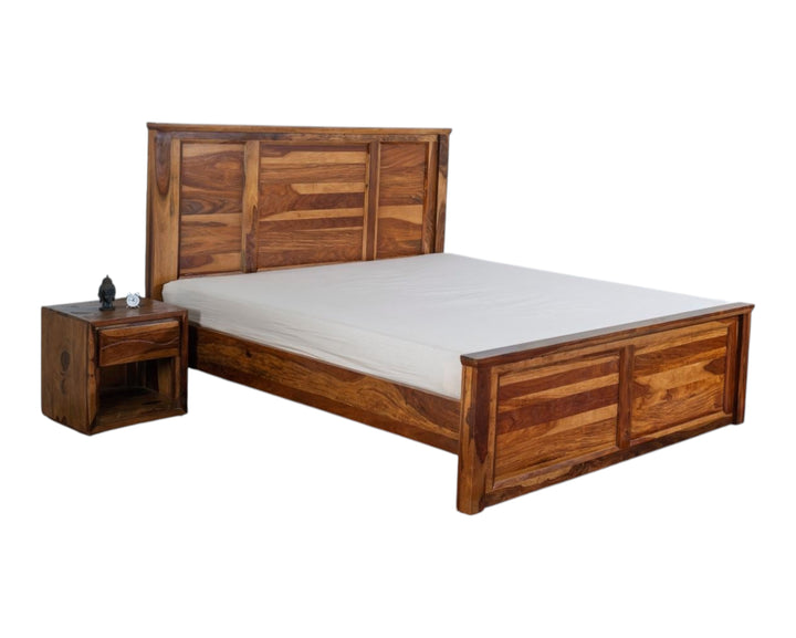 Nakoda Homes solid Sheesham wood platform bed frame with slatted headboard and footboard in honey tone.