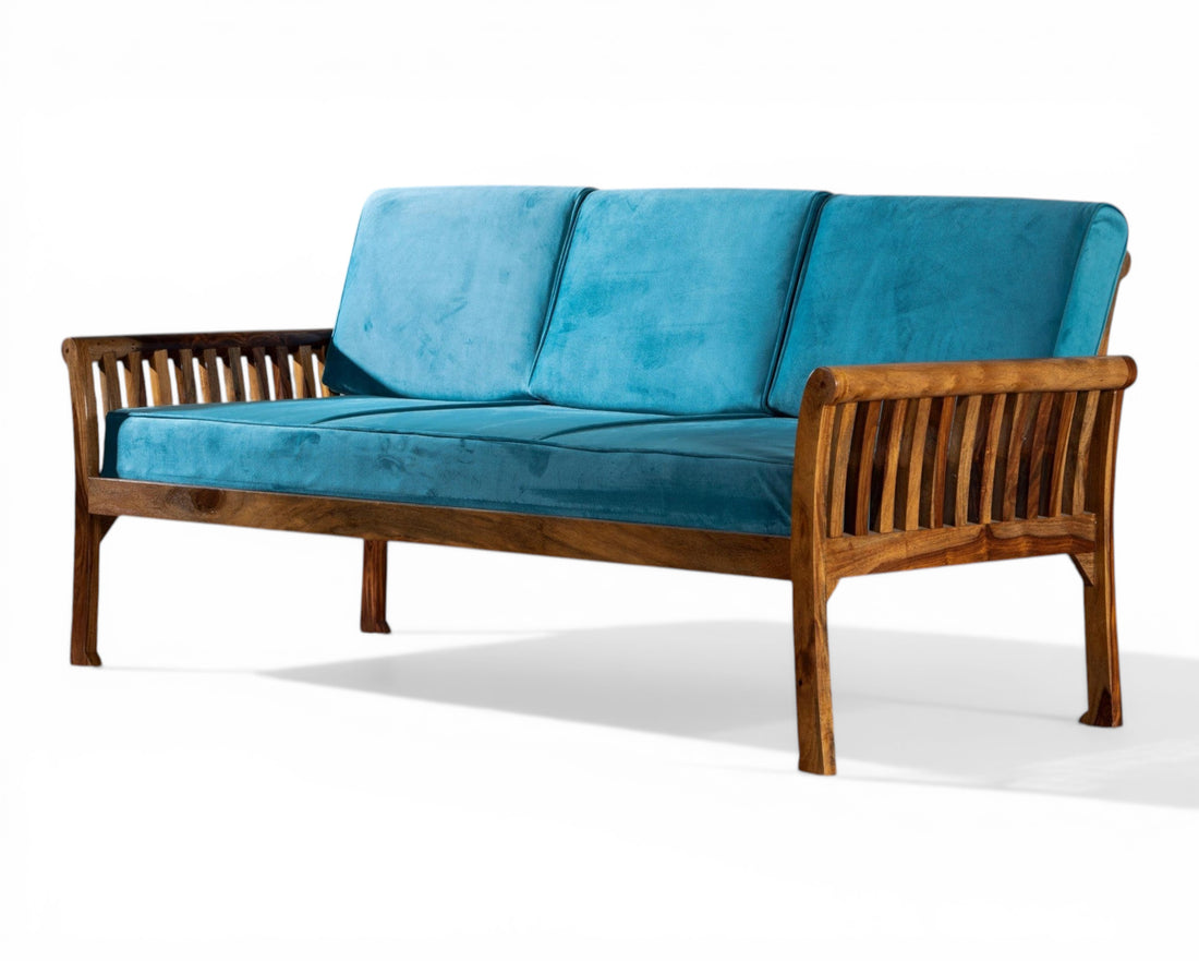 Nakoda Homes solid wood sofa with teal velvet cushions and slatted armrests. Perfect for living rooms.