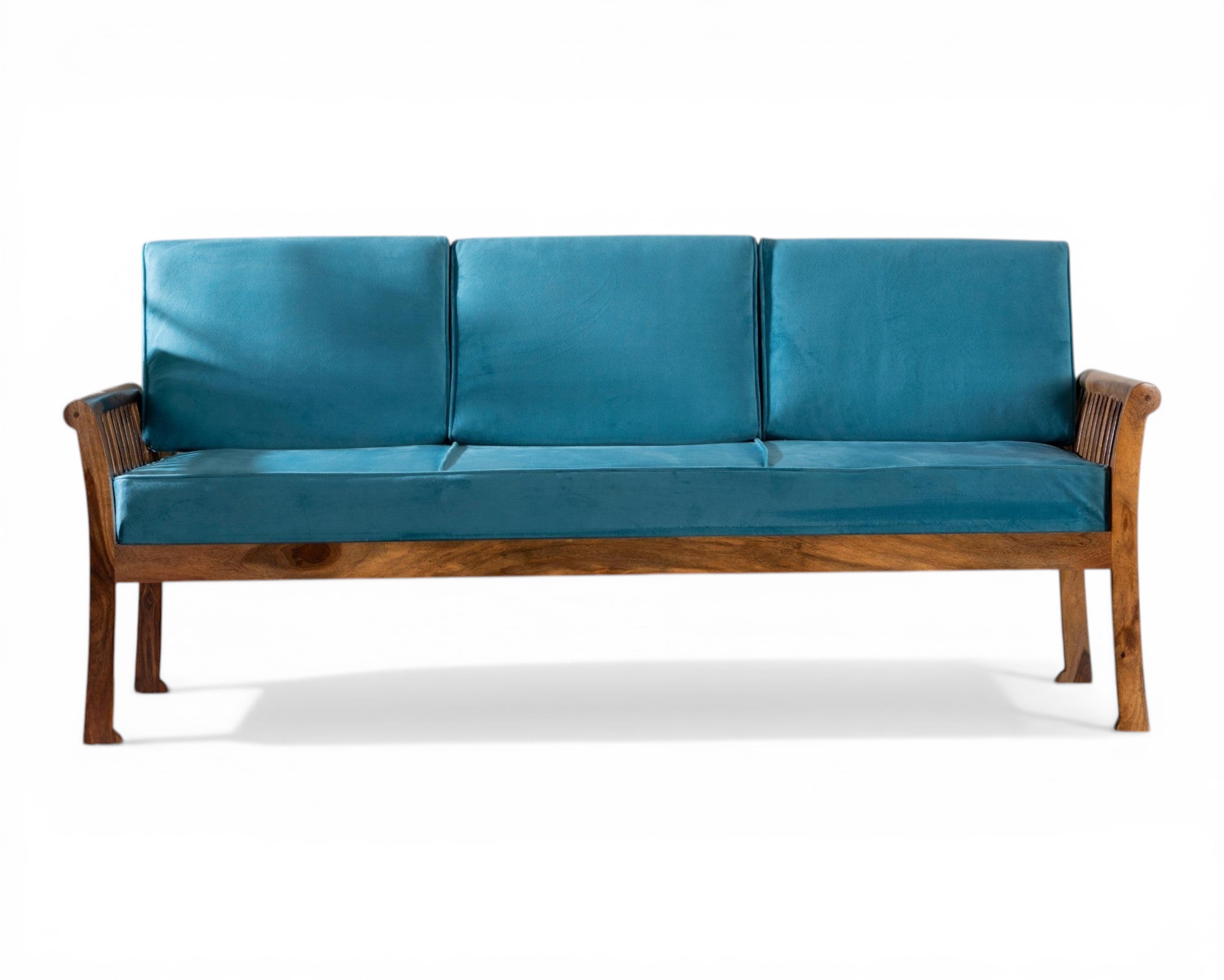 Nakoda Homes solid wood sofa with teal cushions and carved wooden arms. Perfect for living rooms.