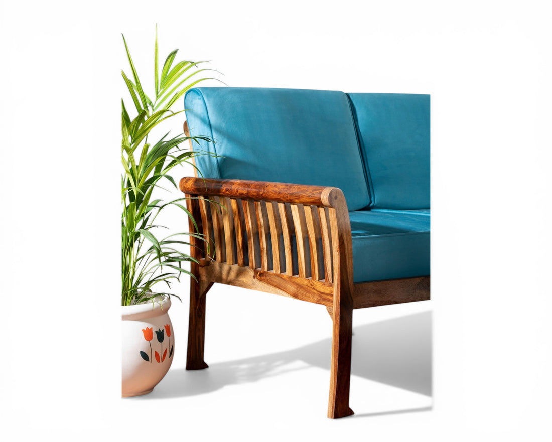 Nakoda Homes solid wood sofa with teal cushions and slatted armrests, perfect for living rooms.