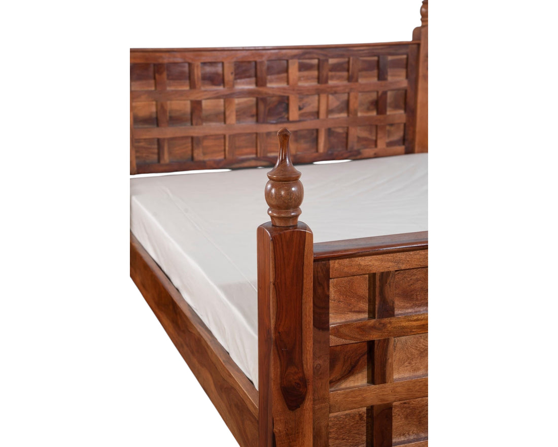 Nakoda Homes solid wood bed frame with lattice headboard and turned posts. Warm-toned wood, traditional design.