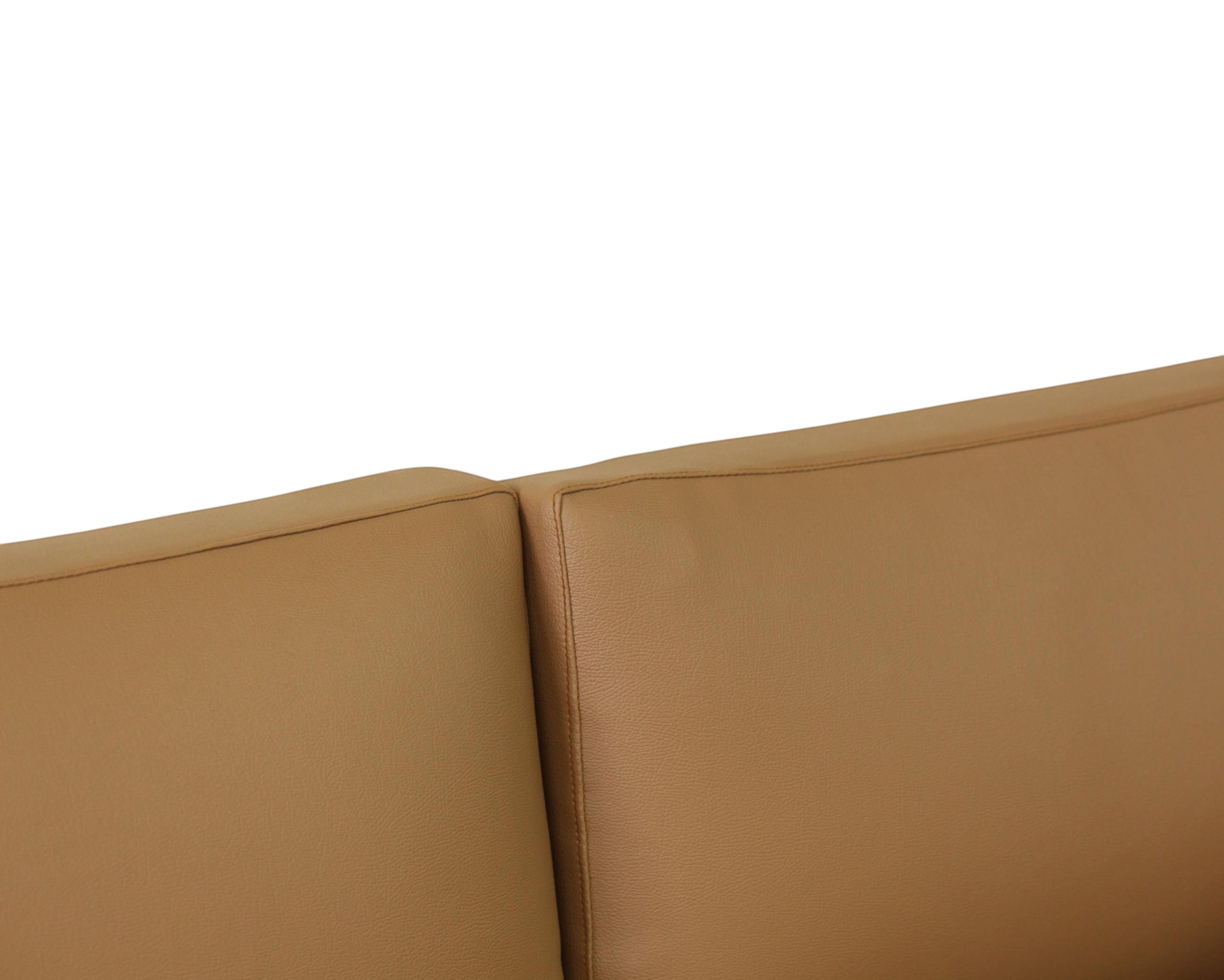 Nakoda Homes tan upholstered three-seater sofa with clean lines and plush comfort.