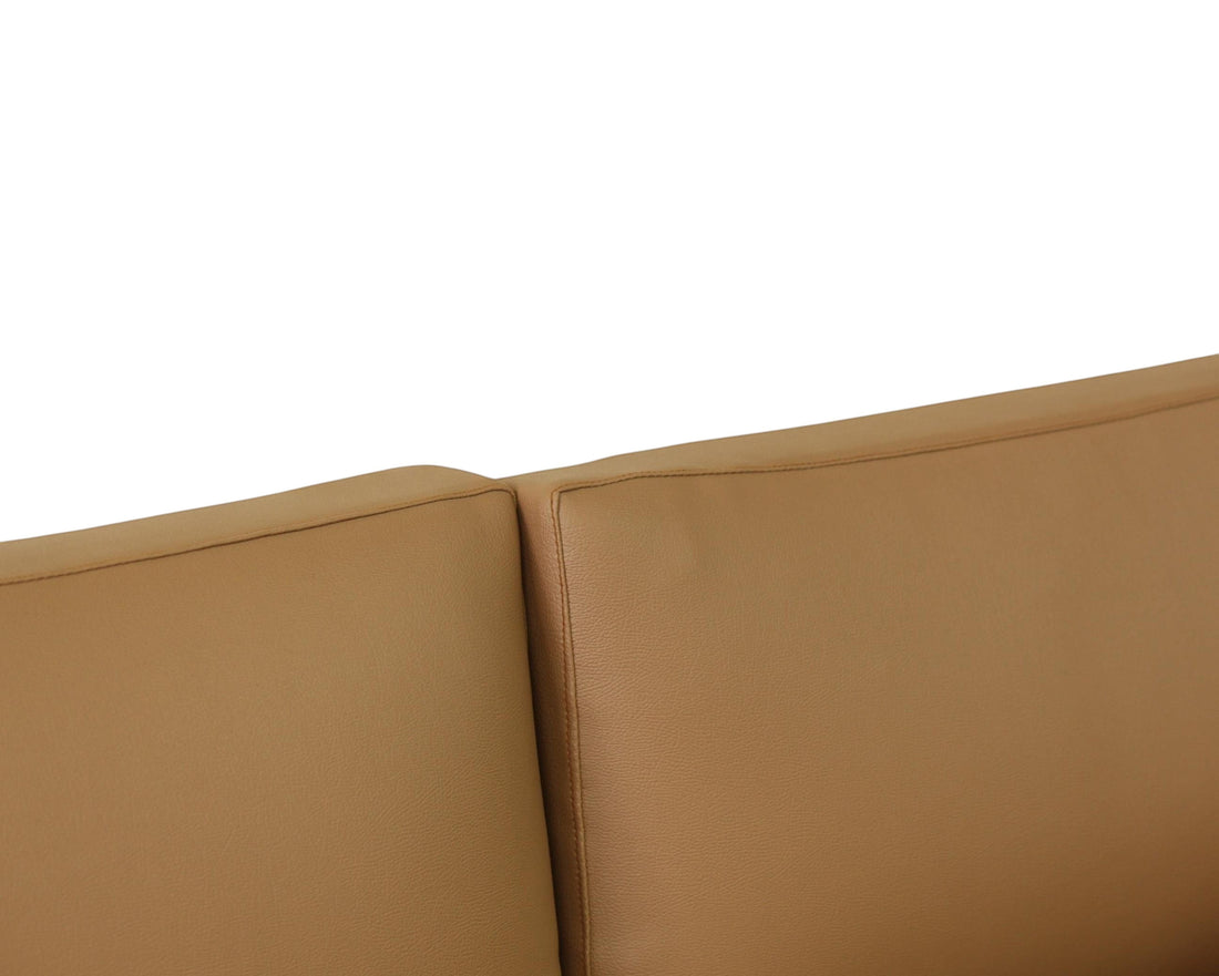 Nakoda Homes tan upholstered three-seater sofa with clean lines and plush comfort.