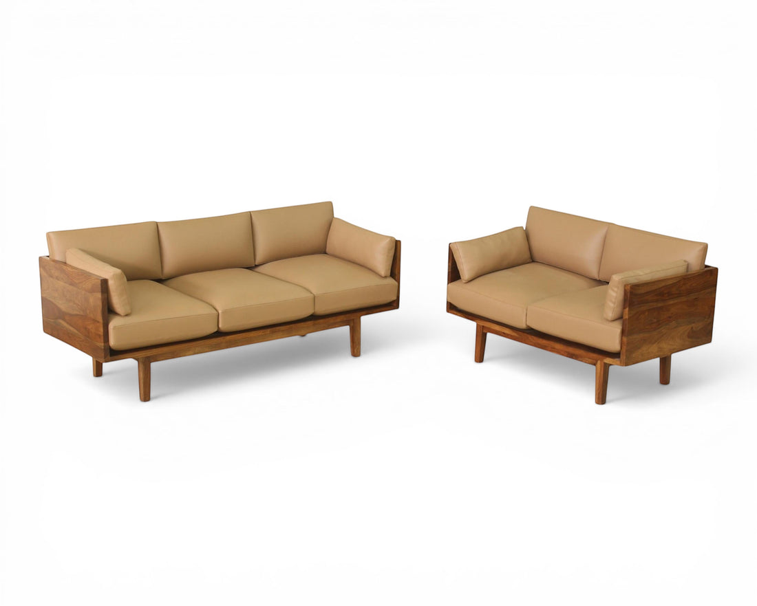 Nakoda Homes modern three-seater sofa with tan upholstery and warm wood frame. Clean lines and minimalist design.