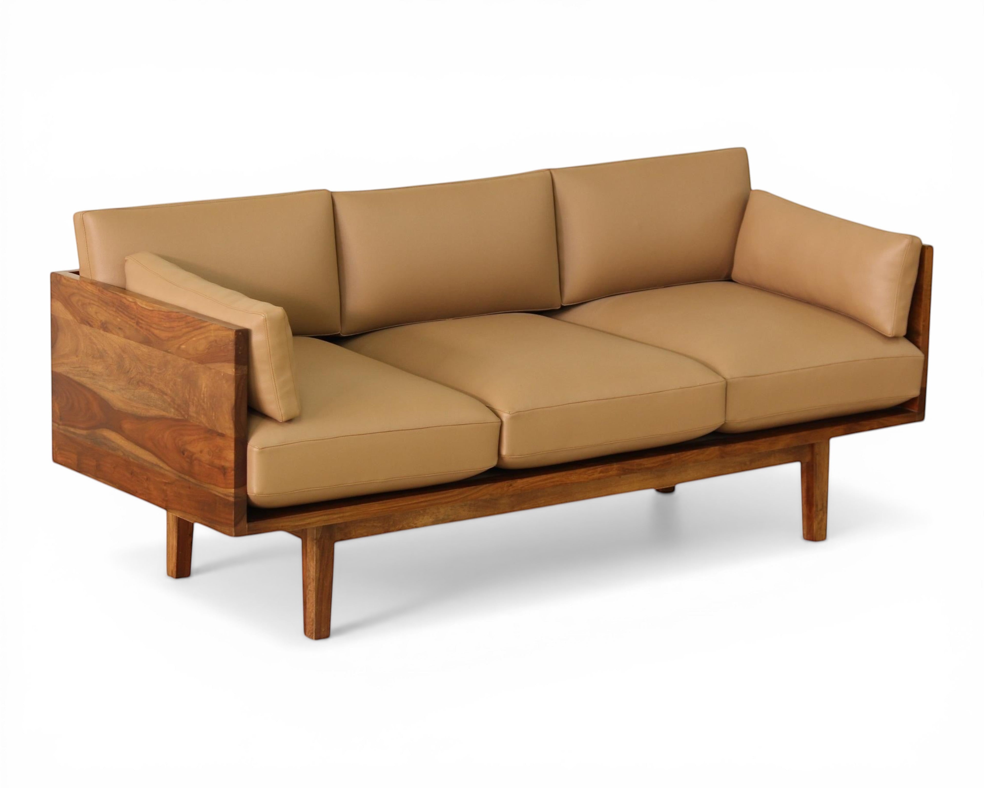 Nakoda Homes tan upholstered three-seater sofa with warm wood frame and clean lines.