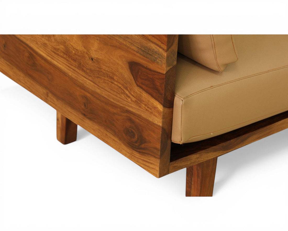 Nakoda Homes modern three-seater sofa with tan upholstery and warm wood frame. Clean lines, minimalist design.