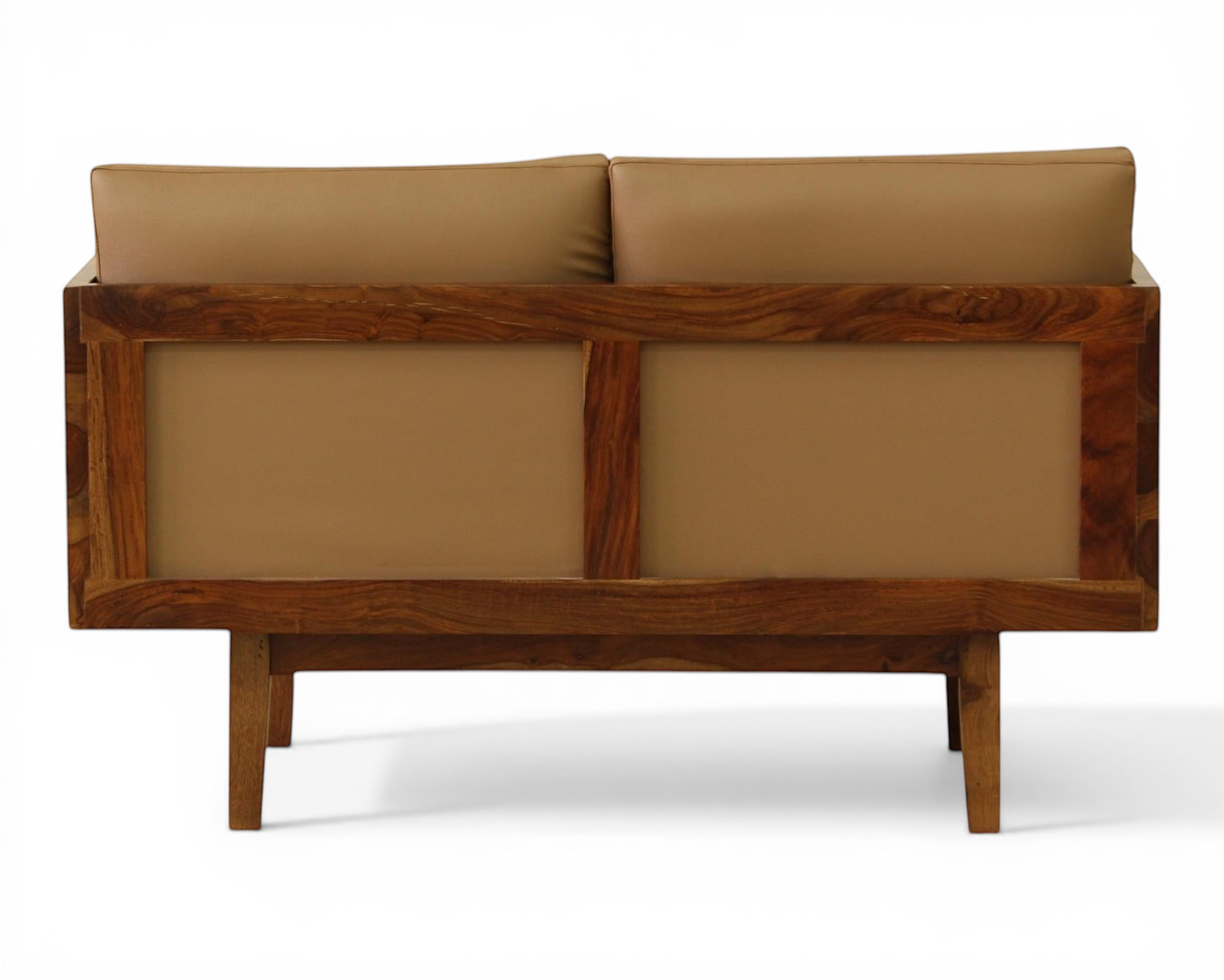 Nakoda Homes modern three-seater sofa with plush tan upholstery and a warm wood frame. Features clean lines and minimalist design.