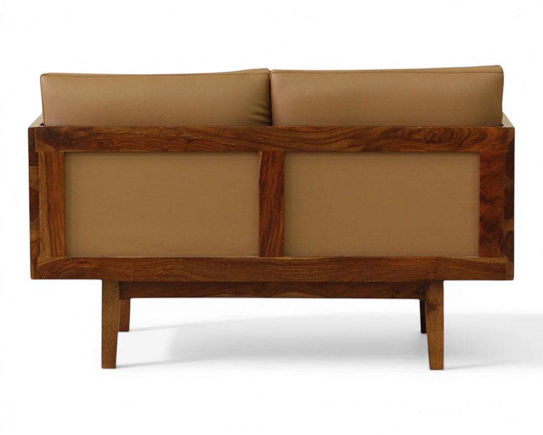Nakoda Homes modern three-seater sofa with plush tan upholstery and a warm wood frame. Features clean lines and minimalist design.