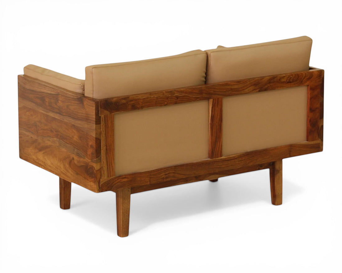 Nakoda Homes modern three-seater sofa with tan upholstery and a warm wood frame. Features clean lines and minimalist design.