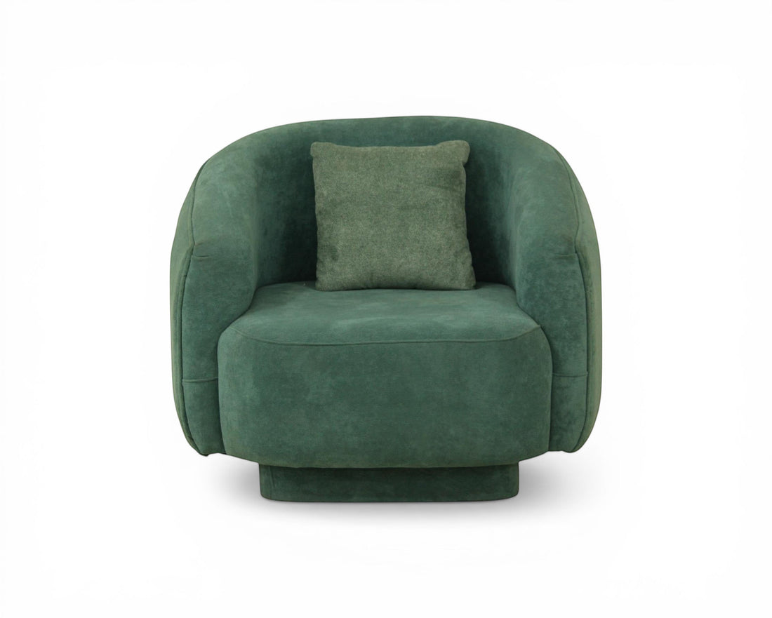 Nakoda Homes teal upholstered armchair with rounded arms and a matching throw pillow. Soft-touch fabric, contemporary style.