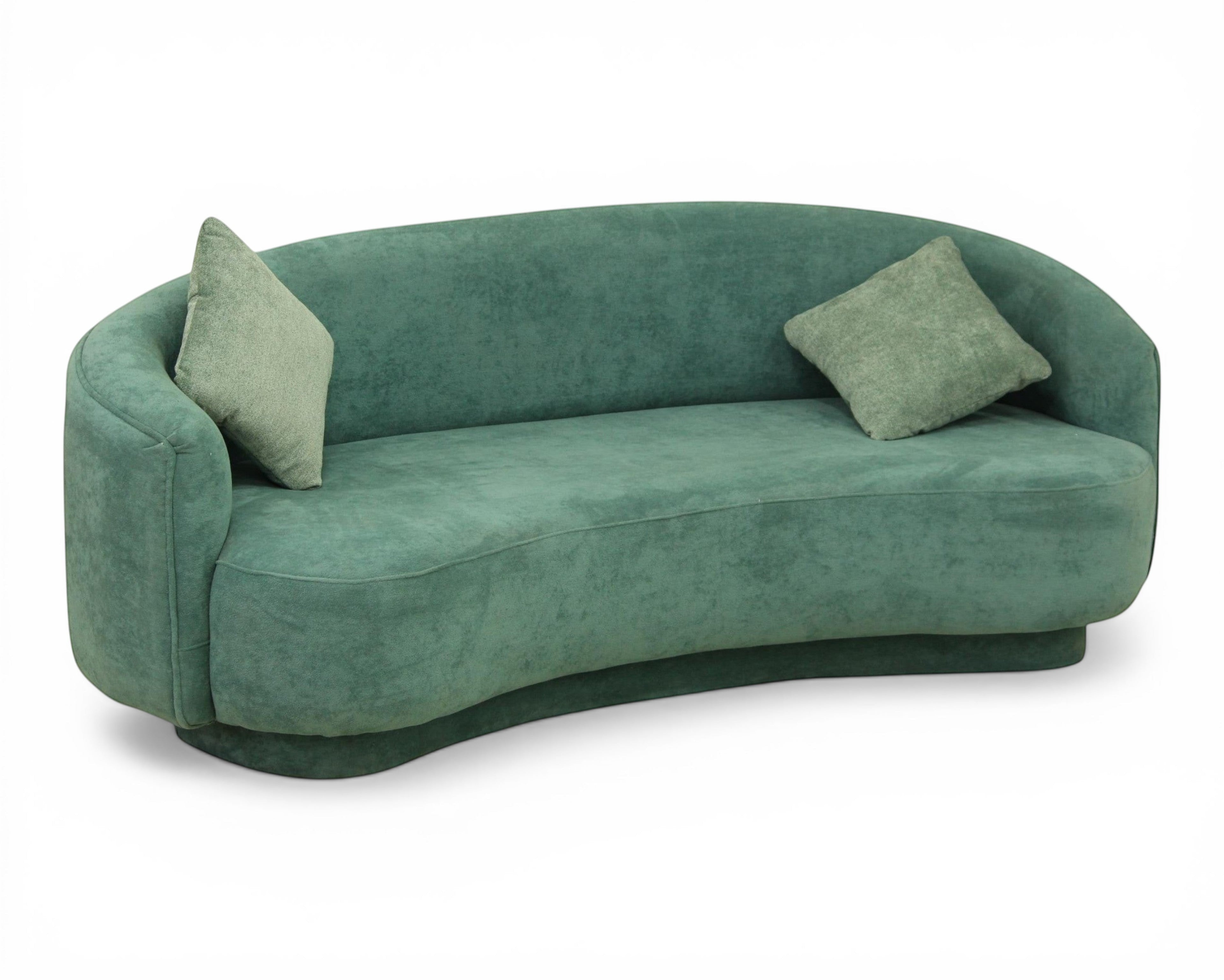 Nakoda Homes teal upholstered curved sofa with rounded arms and two matching throw pillows. Plush fabric, modern style.