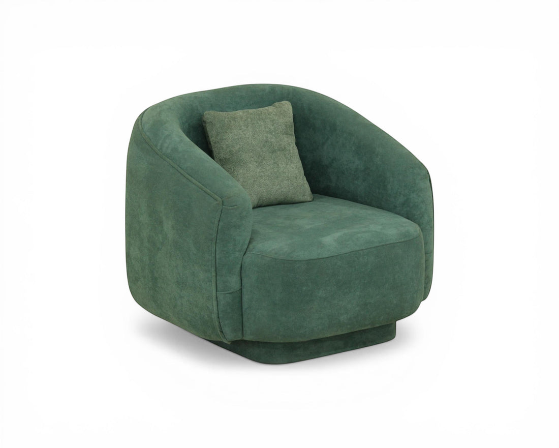 Nakoda Homes teal upholstered armchair with curved silhouette and rounded arms, featuring soft-touch fabric and a matching throw pillow.