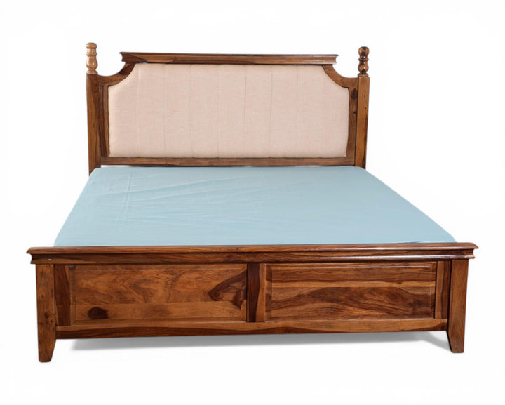 Nakoda Homes classic wooden bed frame with beige upholstered headboard and warm wood finish. Elegant design for a bedroom sanctuary.